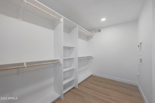 walk in closet featuring light hardwood / wood-style flooring