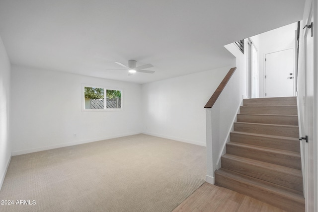 staircase featuring hardwood / wood-style flooring and ceiling fan