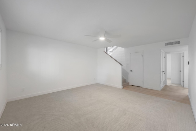 carpeted spare room with ceiling fan