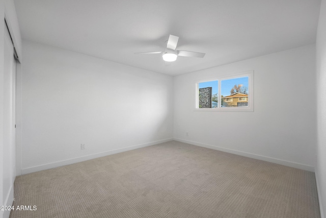 carpeted empty room with ceiling fan