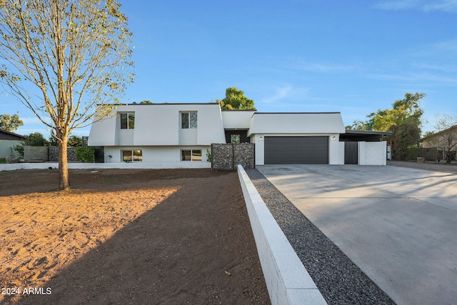 view of front of home with a garage and a carport