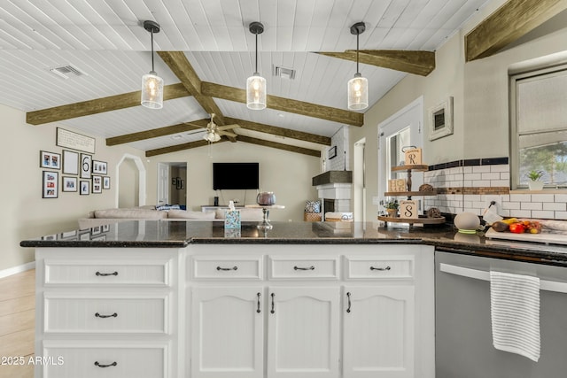 kitchen with dishwasher, open floor plan, visible vents, and decorative backsplash