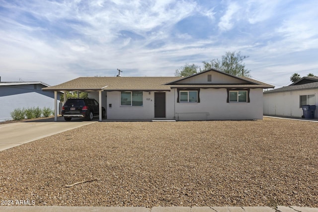 single story home featuring a carport