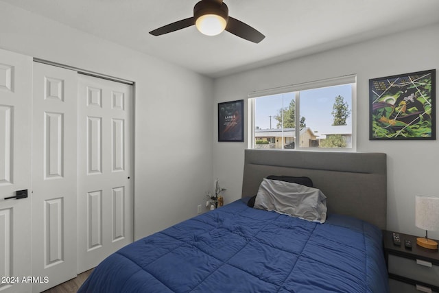 bedroom featuring wood-type flooring, a closet, and ceiling fan