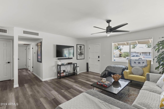 living room with ceiling fan and dark wood-type flooring