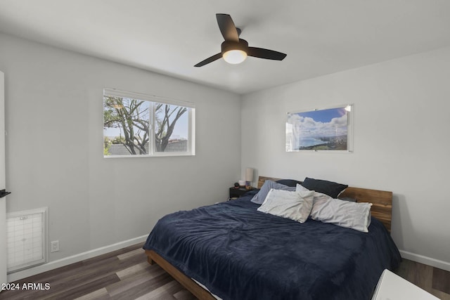 bedroom with ceiling fan and dark wood-type flooring