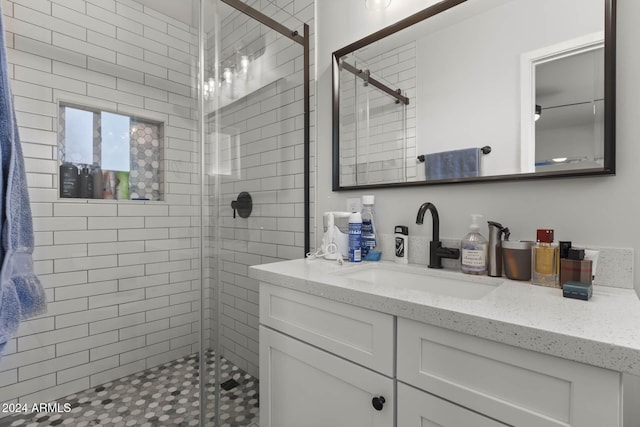 bathroom with vanity and a shower with shower door