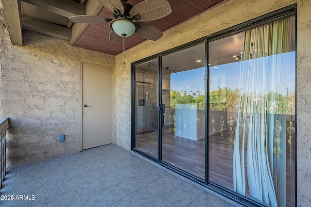 entrance to property with ceiling fan