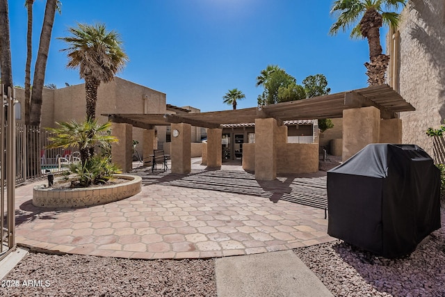 view of patio / terrace with a pergola, area for grilling, and fence