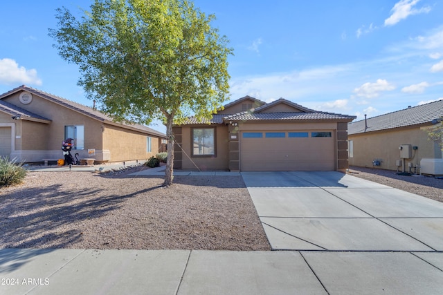 view of front of property featuring central AC unit and a garage