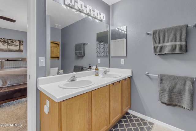 bathroom with ceiling fan, tile patterned flooring, vanity, and toilet