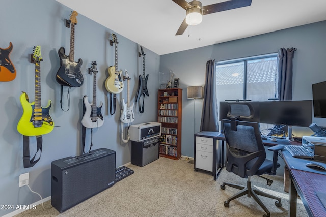 carpeted office space featuring ceiling fan