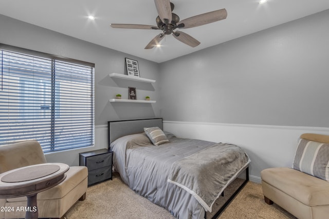 bedroom featuring ceiling fan and light colored carpet