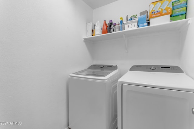 laundry area with washing machine and clothes dryer