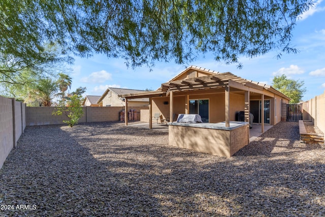 rear view of property featuring area for grilling