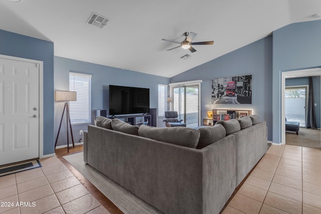 tiled living room with ceiling fan, a wealth of natural light, and vaulted ceiling