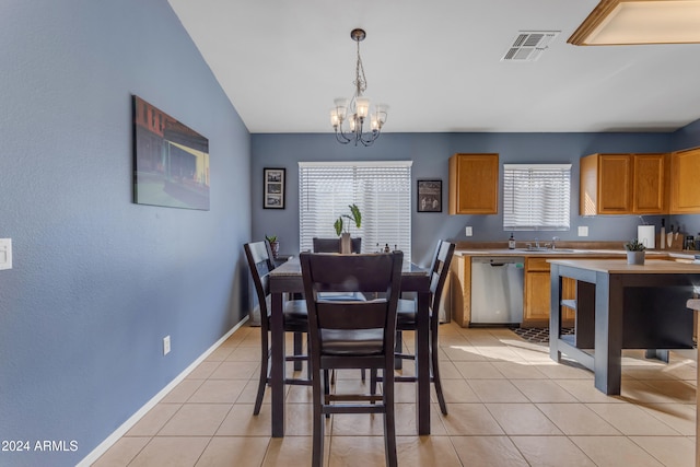 dining room with sink, light tile patterned floors, vaulted ceiling, and a notable chandelier