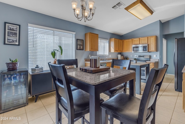 dining room featuring light tile patterned floors, wine cooler, plenty of natural light, and lofted ceiling