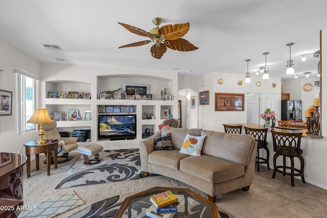 living room with ceiling fan, light tile patterned floors, and built in features