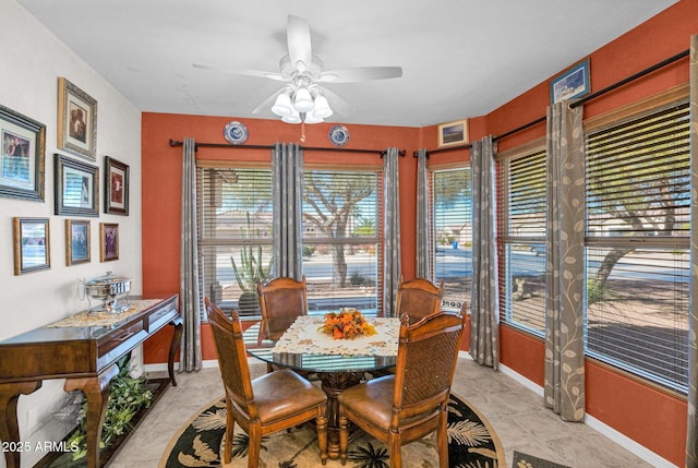 tiled dining room featuring ceiling fan