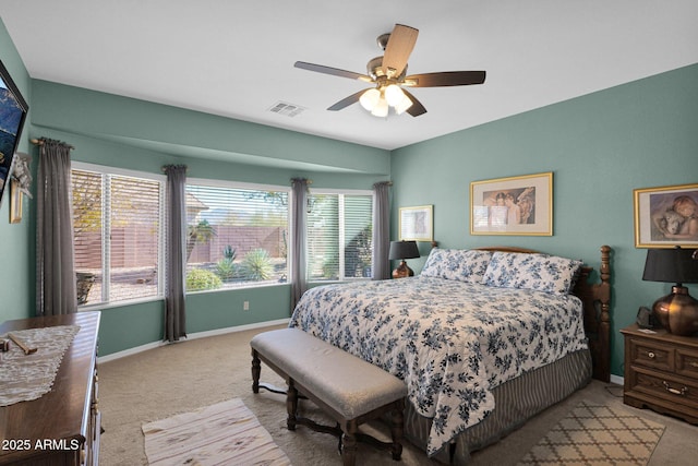 carpeted bedroom featuring ceiling fan and multiple windows