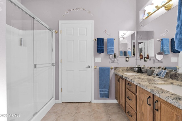 bathroom with tile patterned floors, vanity, and a shower with shower door