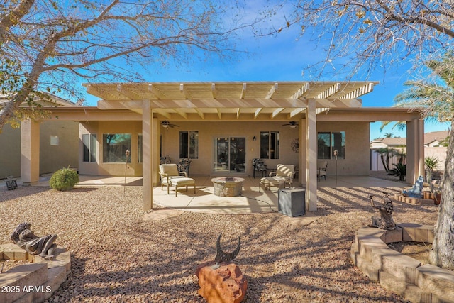 rear view of property featuring a pergola, a patio area, an outdoor fire pit, and ceiling fan