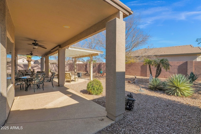 view of patio / terrace with ceiling fan and a pergola