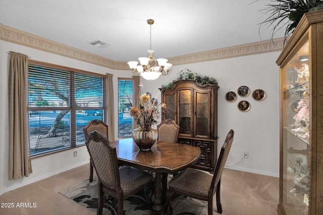 carpeted dining area featuring an inviting chandelier and crown molding