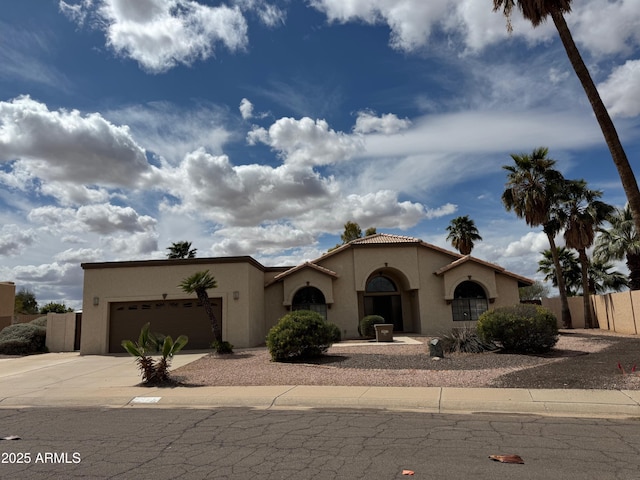 2077 N Lake Shore Dr, Casa Grande, AZ 85122 - view of front of home featuring fence, a tiled roof, an attached garage, stucco siding, and driveway