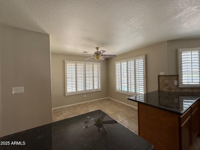 2077 N Lake Shore Dr, Casa Grande, AZ 85122 - kitchen with tasteful backsplash, light tile patterned floors, baseboards, dark countertops, and a ceiling fan