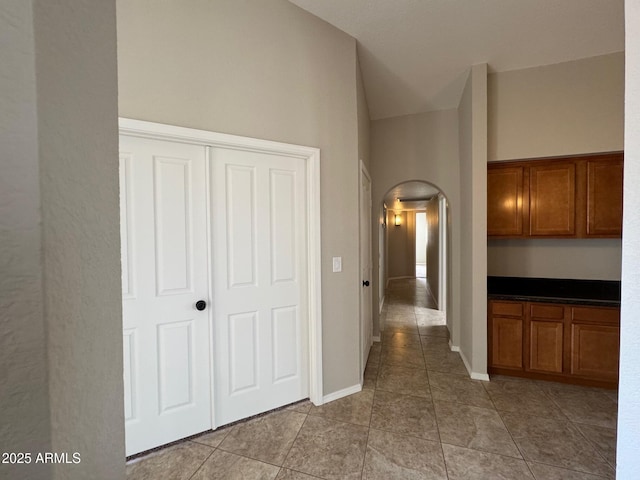 2077 N Lake Shore Dr, Casa Grande, AZ 85122 - hall with light tile patterned floors, arched walkways, and baseboards