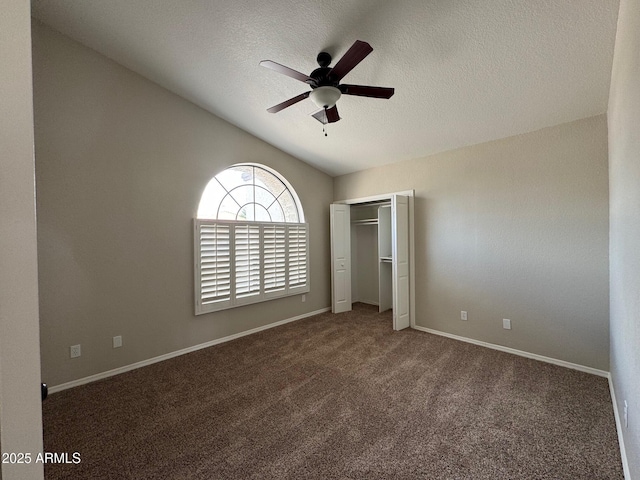 2077 N Lake Shore Dr, Casa Grande, AZ 85122 - unfurnished bedroom featuring a closet, a textured ceiling, baseboards, lofted ceiling, and carpet floors