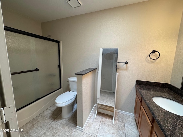 2077 N Lake Shore Dr, Casa Grande, AZ 85122 - bathroom with vanity, shower / bath combination with glass door, toilet, baseboards, and tile patterned floors