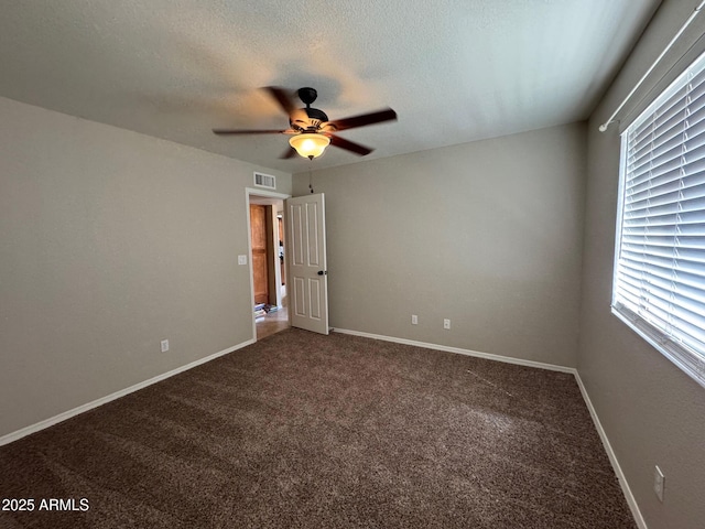 2077 N Lake Shore Dr, Casa Grande, AZ 85122 - empty room with baseboards, a textured ceiling, carpet floors, visible vents, and ceiling fan