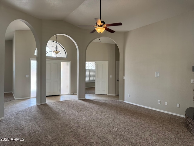 2077 N Lake Shore Dr, Casa Grande, AZ 85122 - interior space with light carpet, arched walkways, ceiling fan, and light tile patterned floors