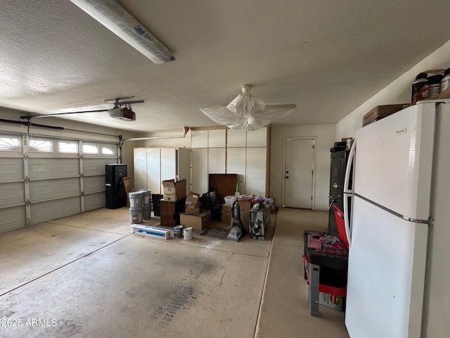 2077 N Lake Shore Dr, Casa Grande, AZ 85122 - garage with a garage door opener and freestanding refrigerator