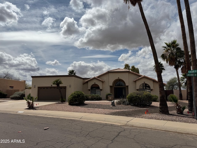 2077 N Lake Shore Dr, Casa Grande, AZ 85122 - mediterranean / spanish house with a tiled roof, stucco siding, concrete driveway, and a garage
