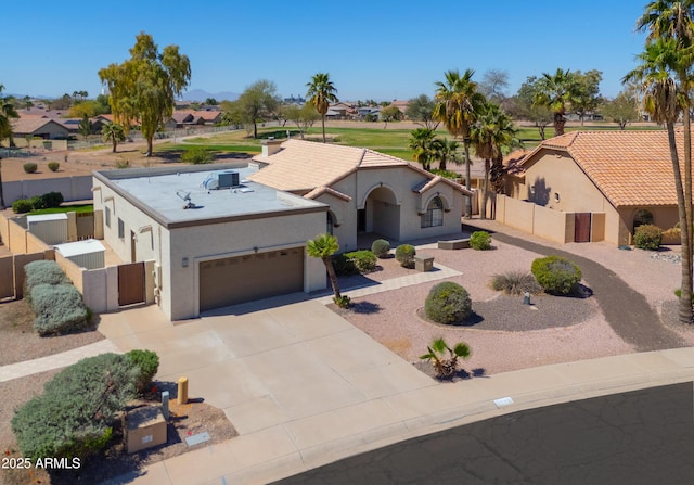 2077 N Lake Shore Dr, Casa Grande, AZ 85122 - view of front of property featuring stucco siding, an attached garage, fence, and driveway