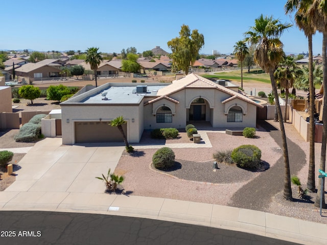 2077 N Lake Shore Dr, Casa Grande, AZ 85122 - view of front of home featuring driveway, fence, an attached garage, a residential view, and stucco siding
