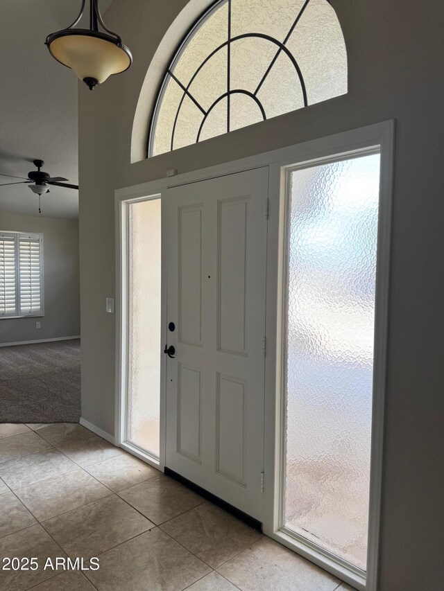 2077 N Lake Shore Dr, Casa Grande, AZ 85122 - entrance foyer featuring carpet flooring, a ceiling fan, tile patterned floors, and baseboards