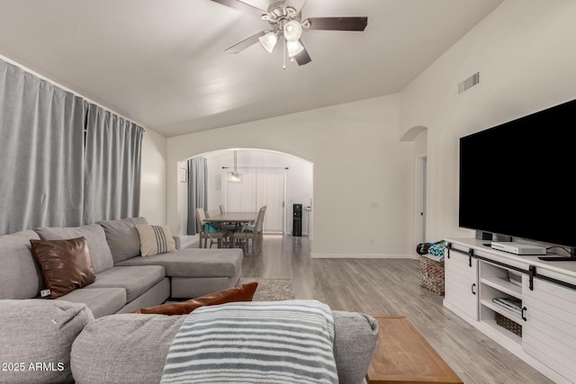 living room with vaulted ceiling, light hardwood / wood-style floors, and ceiling fan