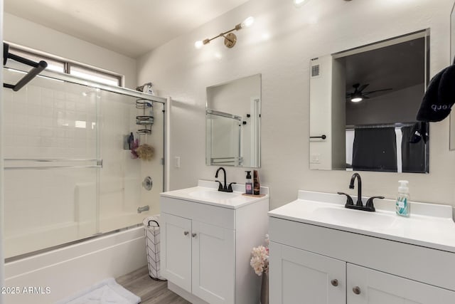 bathroom with enclosed tub / shower combo, hardwood / wood-style floors, vanity, and ceiling fan