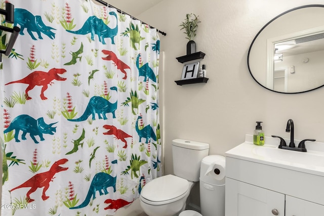 bathroom featuring vanity, a shower with curtain, and toilet