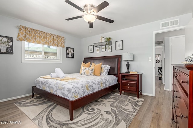 701 N 55th Pl, Mesa, AZ 85205 - bedroom with light wood-style floors, baseboards, and ceiling fan