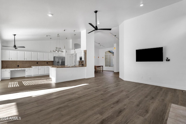 unfurnished living room featuring dark hardwood / wood-style floors, high vaulted ceiling, and ceiling fan