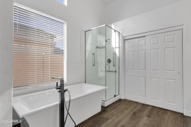 bathroom with wood-type flooring and independent shower and bath