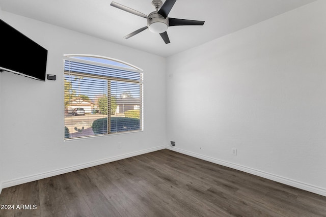 unfurnished room with ceiling fan and dark wood-type flooring