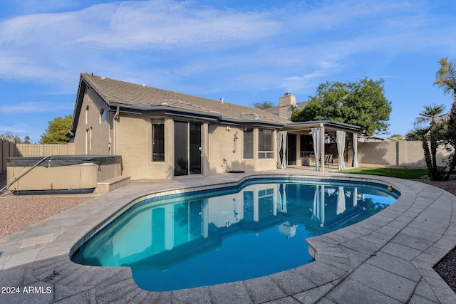 view of swimming pool with a hot tub and a patio area