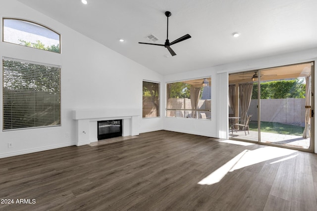 unfurnished living room featuring high vaulted ceiling and dark wood-type flooring